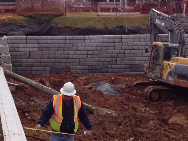 Measurements are made in preparation to extend this Redirock seawall that is being constructed.