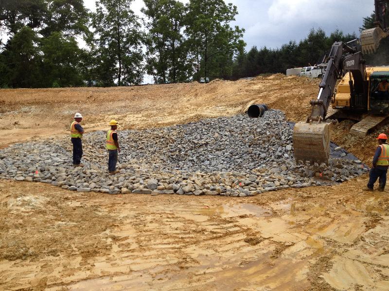 Rip rap is being placed in the forebay of the storm water retention pond